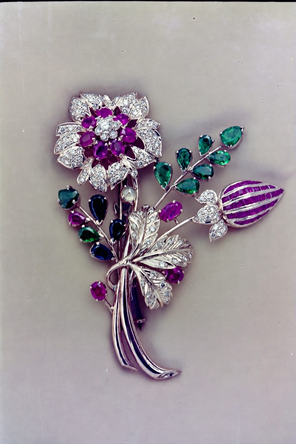 A BDK ruby, emerald and diamond floral spray brooch, archival photograph